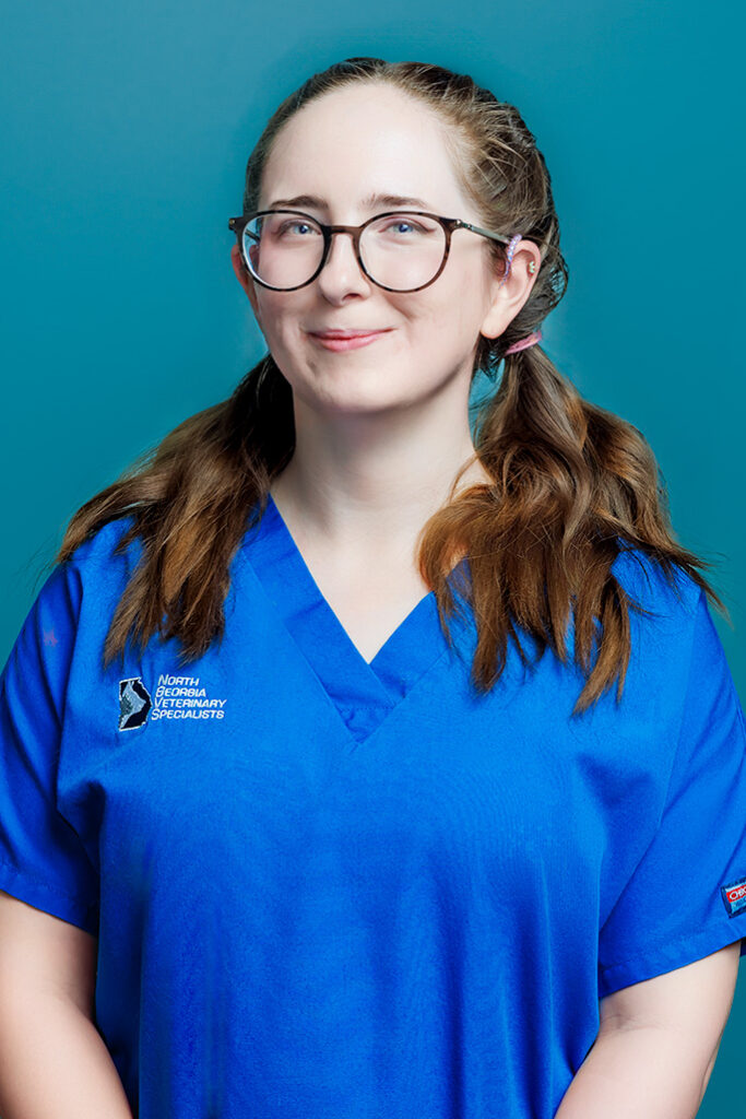 a woman wearing glasses and a blue shirt